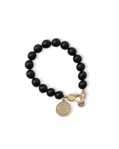 Bracciale elastico con sfere in vetro nere e medaglietta in metallo