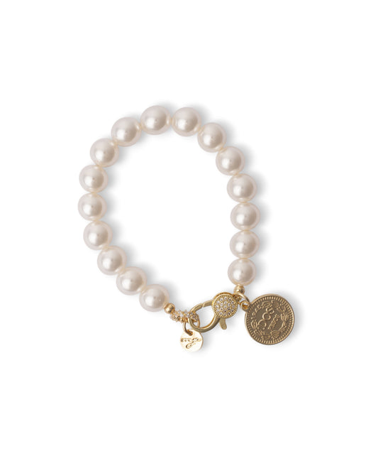 Bracciale elastico con sfere in vetro perlate e medaglietta in metallo