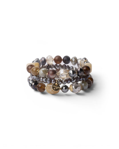 Bracciale elastico a tre fili con pietre in vetro ed acrilico tono beige/grigio