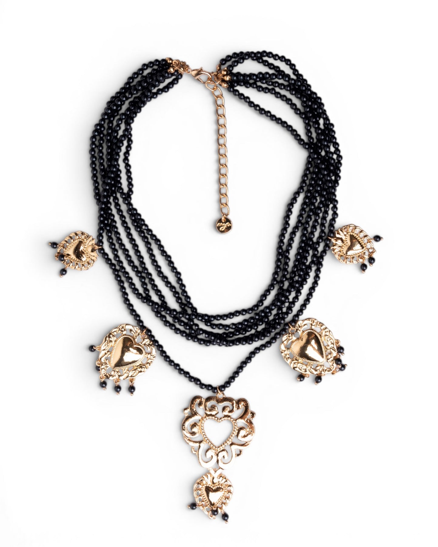 Collana multi fili con micro pietre in acrilico nere e cuori sacri pendenti