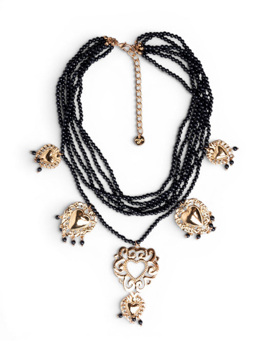 Collana multi fili con micro pietre in acrilico nere e cuori sacri pendenti