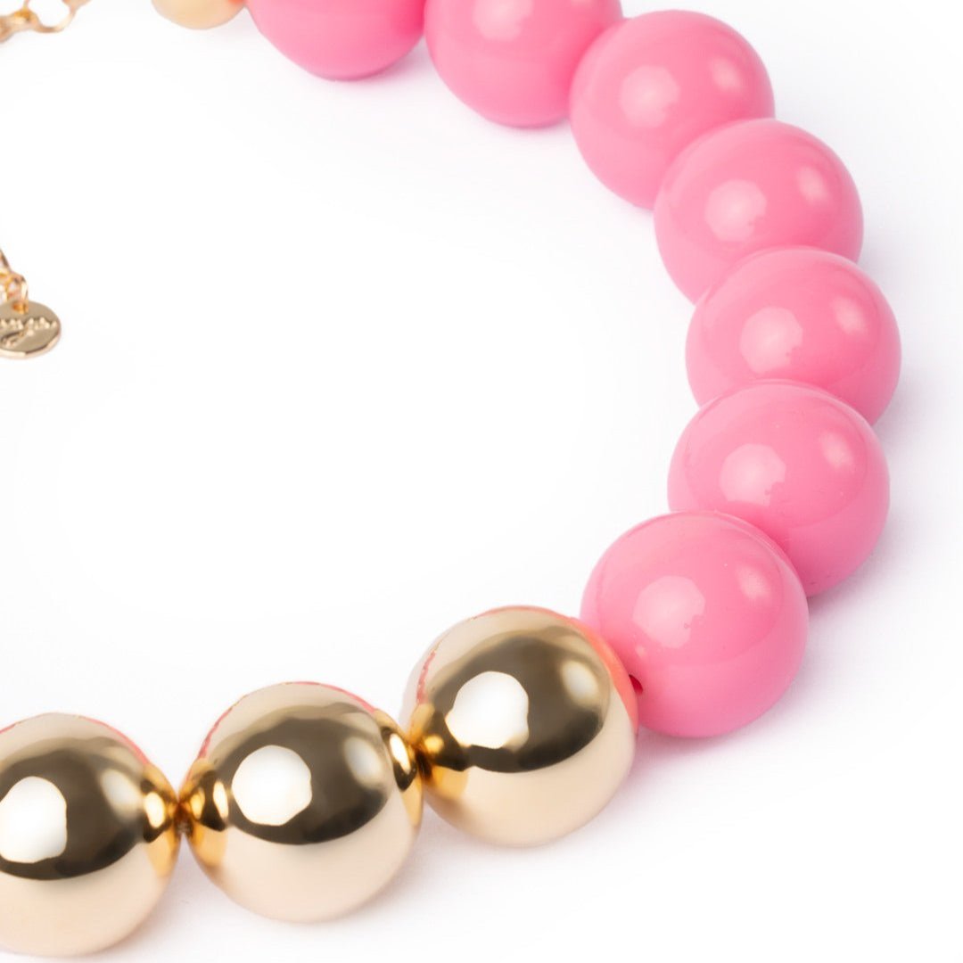 Collana girocollo in acrilico con sfere rosa di cui tre placcate in oro - Mya Accessories