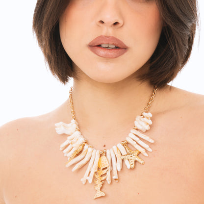 Collana girocollo con rami di corallo beige in acrilico ed elementi marini in metallo pendenti
