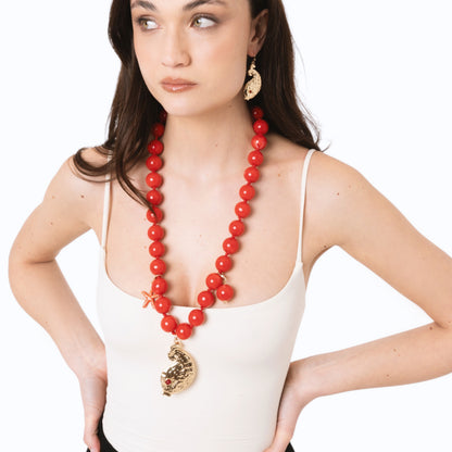 Collana lunga con sfere rosse in acrilico e pendente pesciolino in metallo